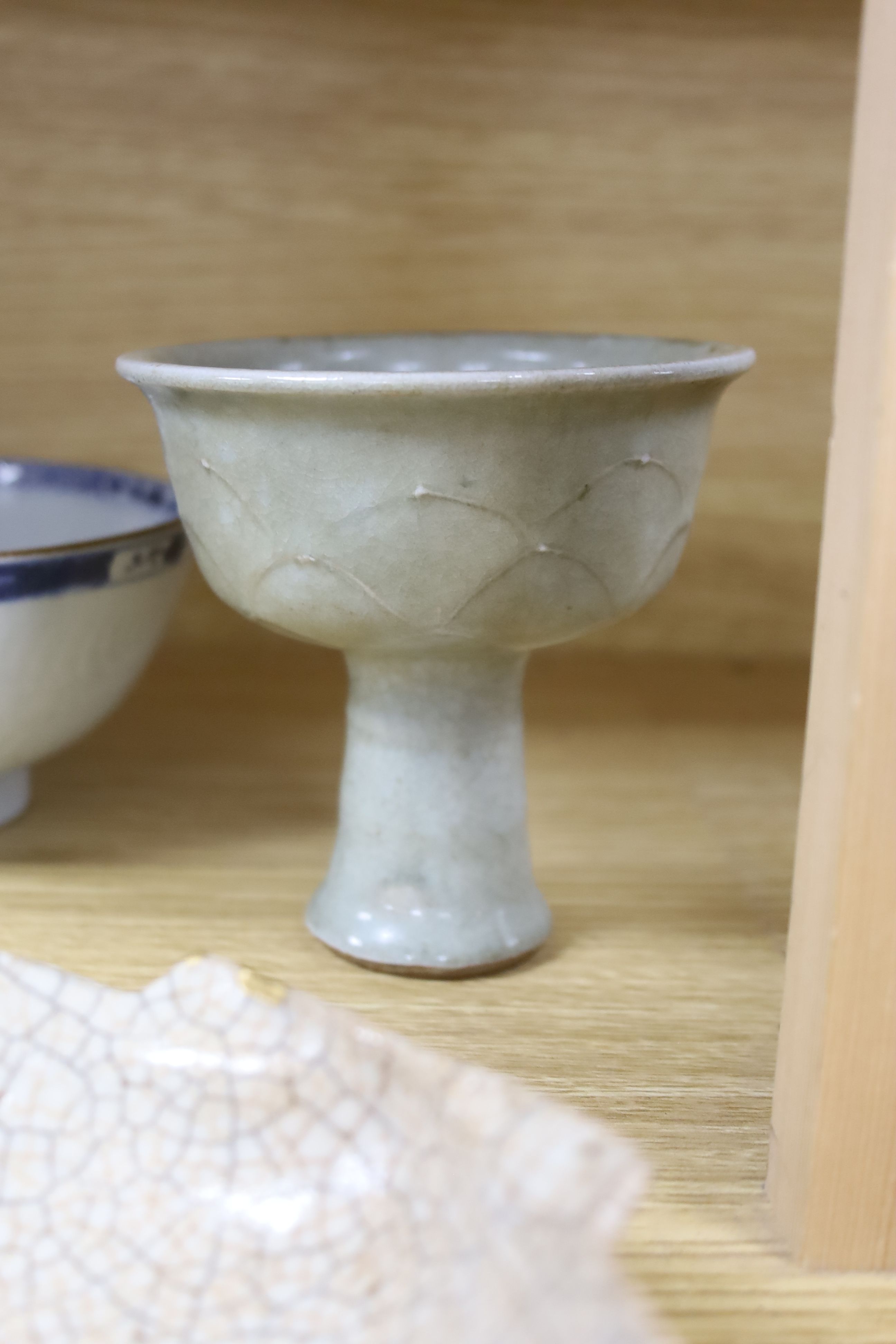 A Chinese blue and white bowl, diameter 15cm, a tea bowl and saucer, a crackleglaze shell dish and a celadon glazed stem cup